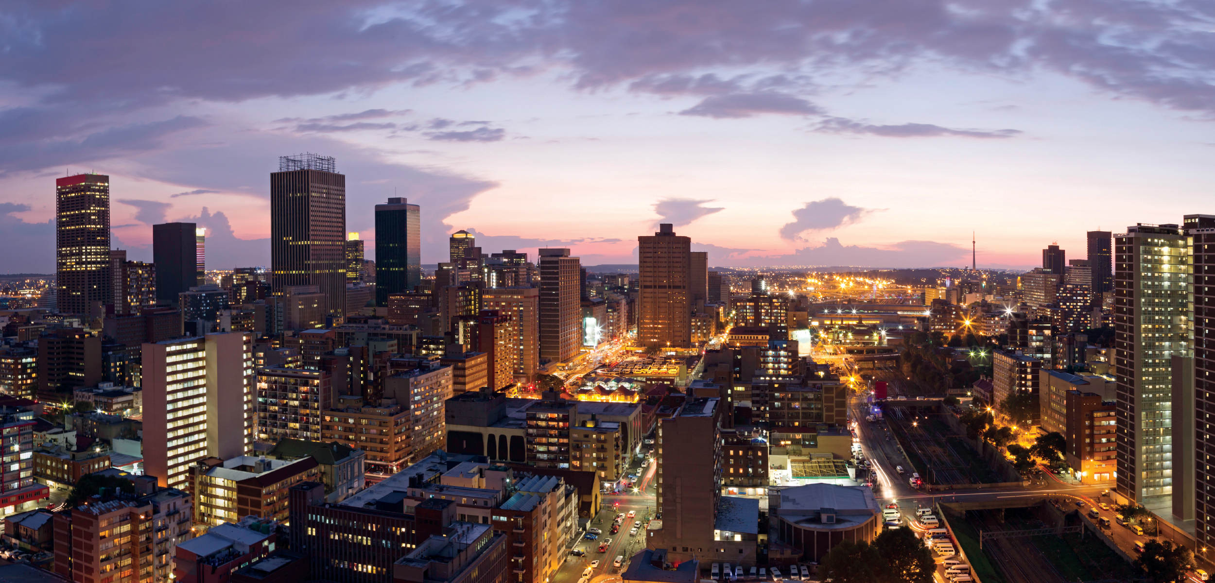 a city with many tall buildings and a road