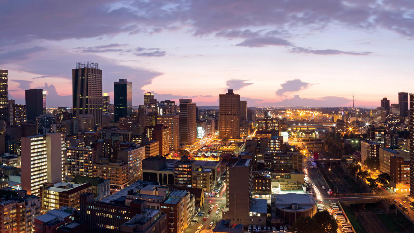 a city with many tall buildings and a road
