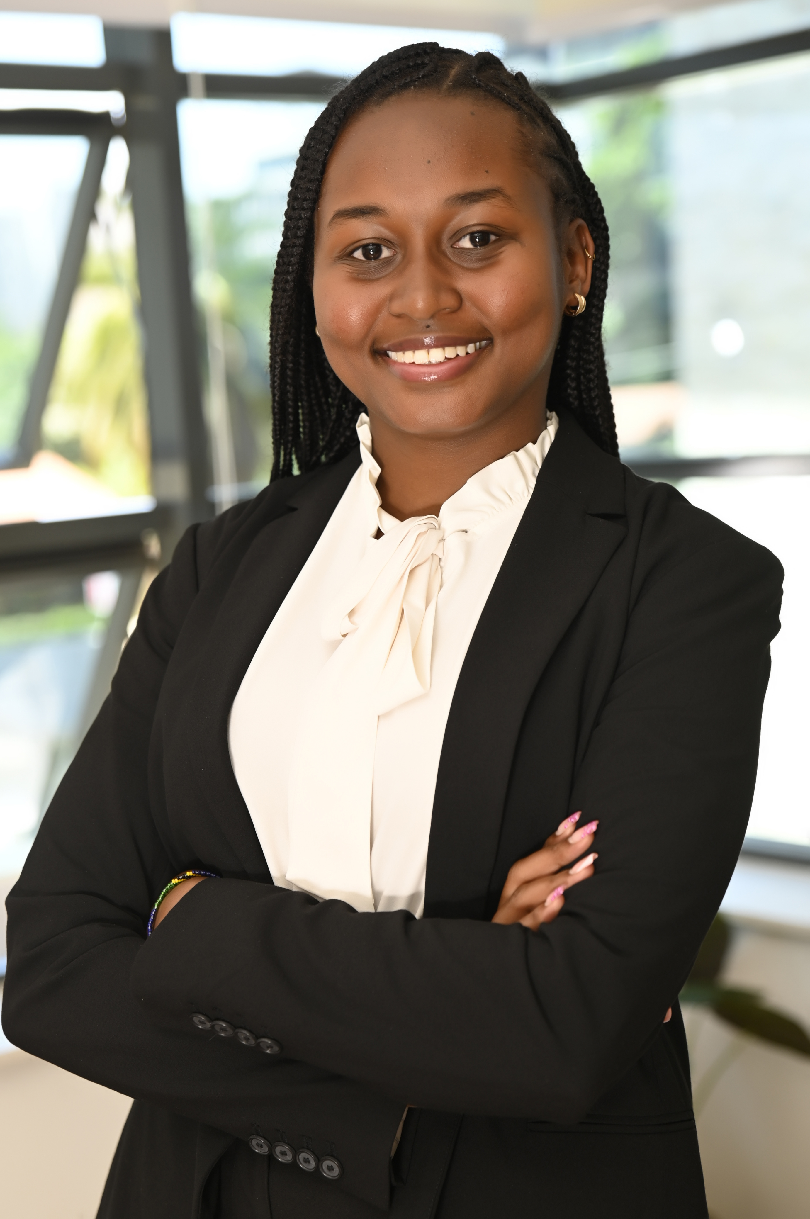 a woman in a suit with her arms crossed