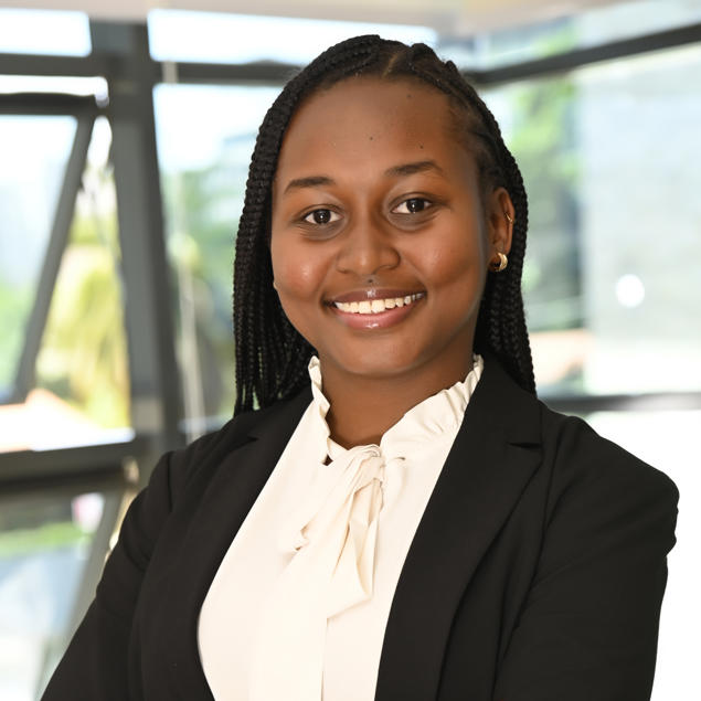 a woman in a suit with her arms crossed