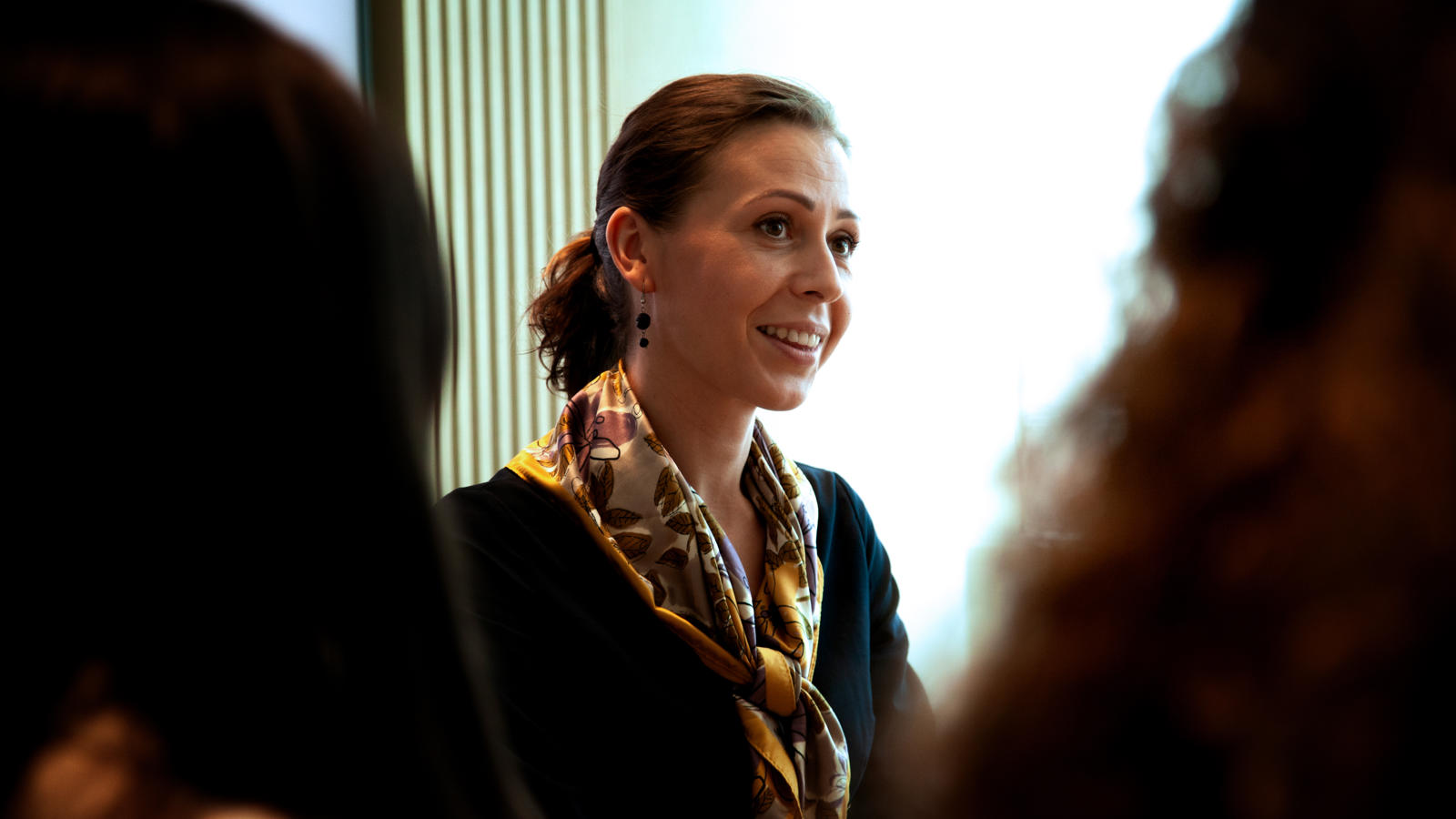 a woman smiling in a room