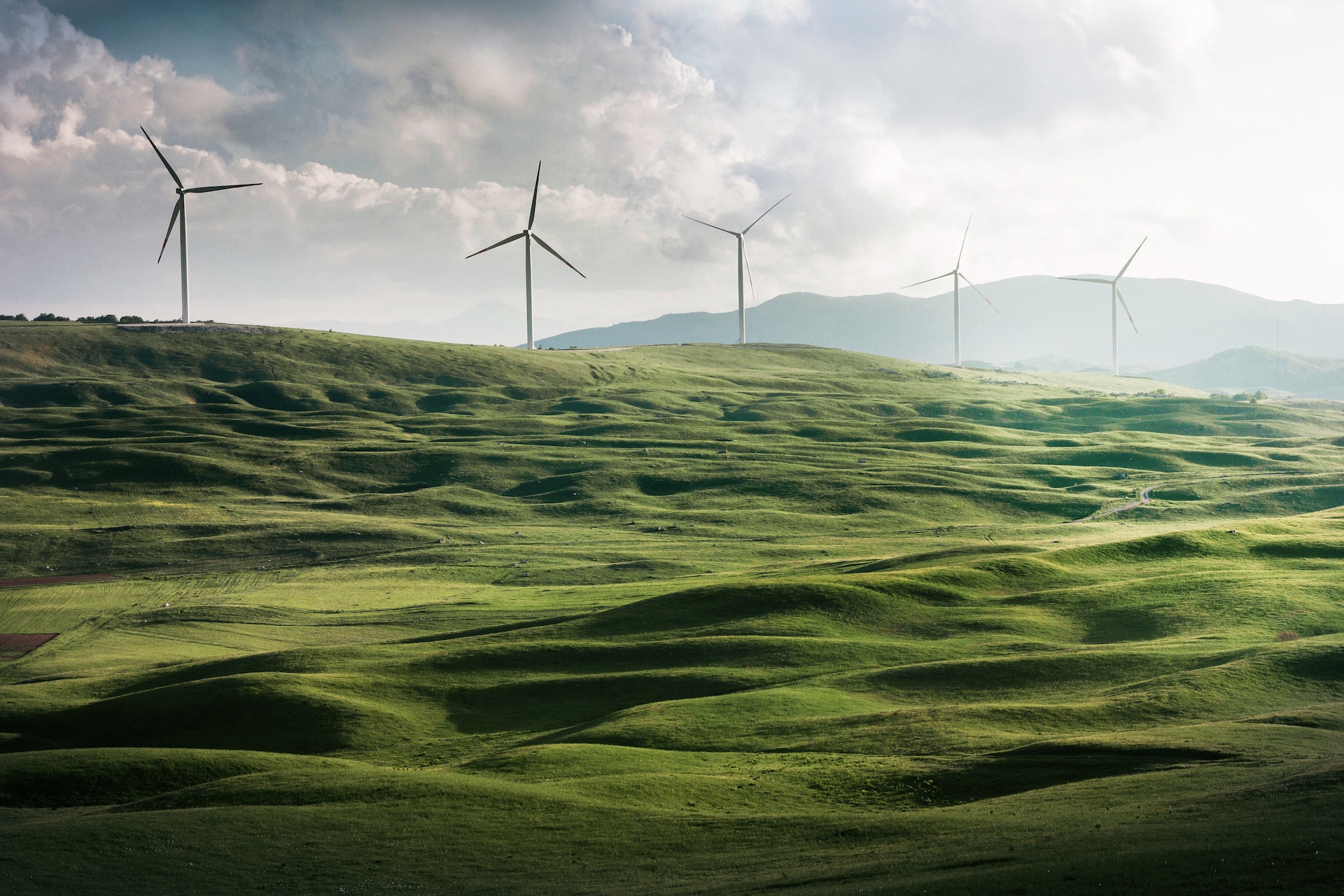 a wind turbines on a green hill