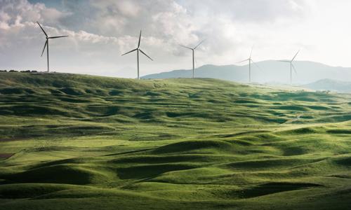 a wind turbines on a green hill