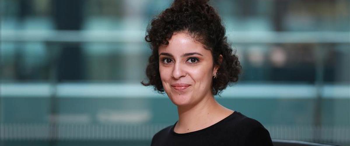 a woman with curly hair wearing a black shirt