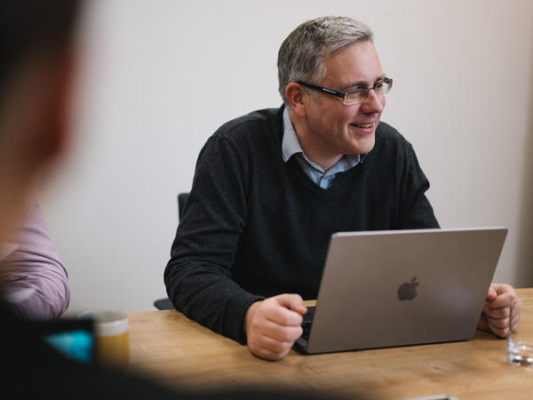 a man sitting at a table with a laptop
