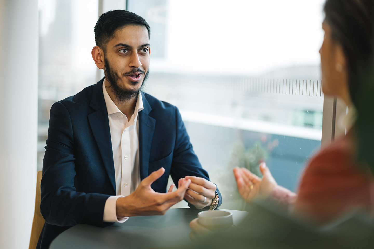 a man in a suit talking to a woman