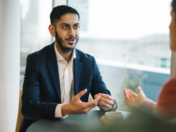 a man in a suit talking to a woman