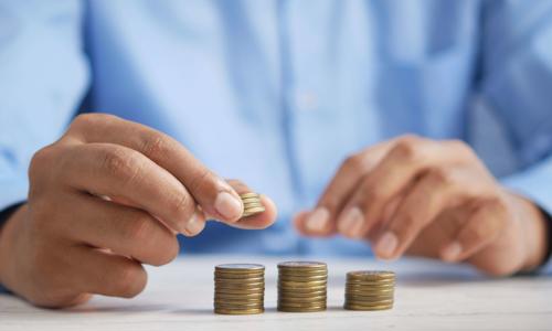 a person stacking coins
