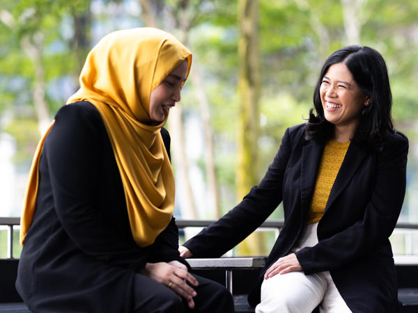 two women sitting on a bench