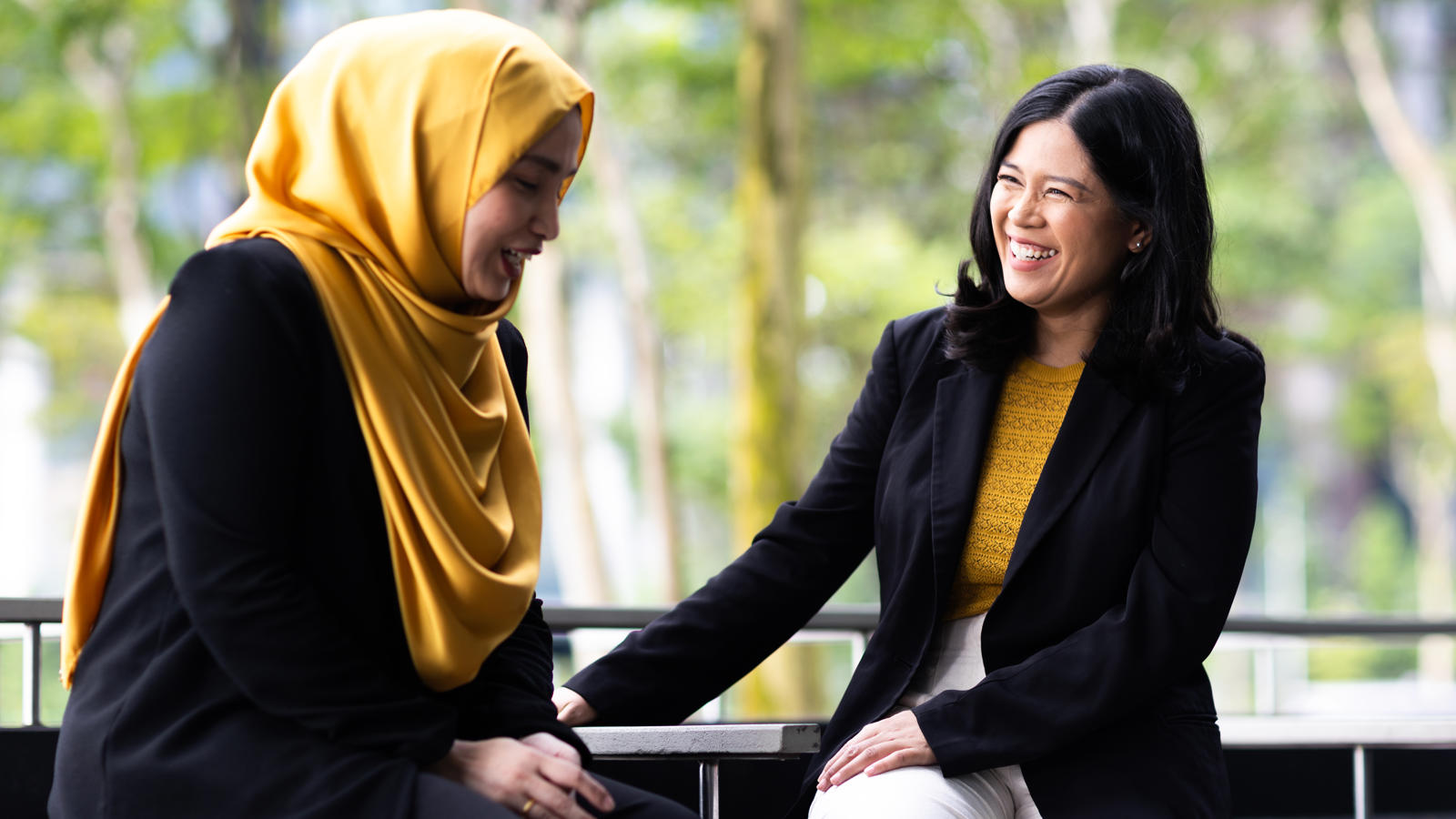 two women sitting on a bench