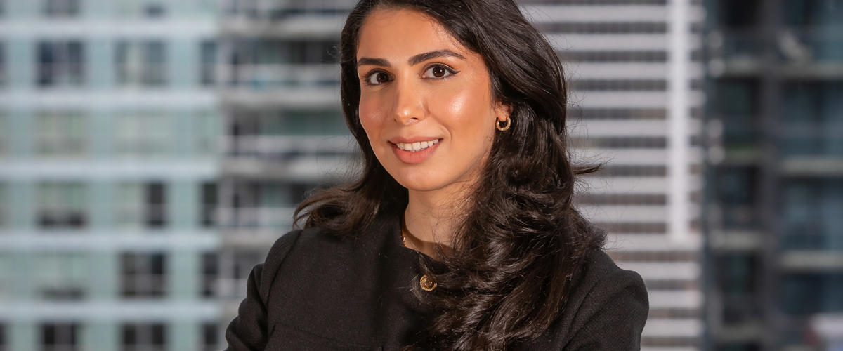 a woman with long hair wearing a black jacket