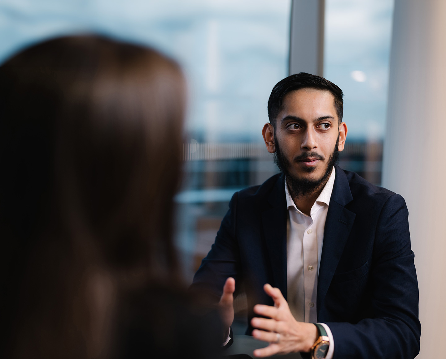 a man in a suit talking to a woman