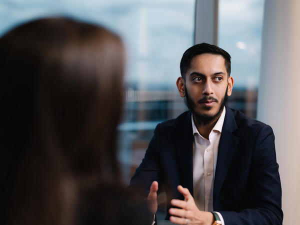 a man in a suit talking to a woman