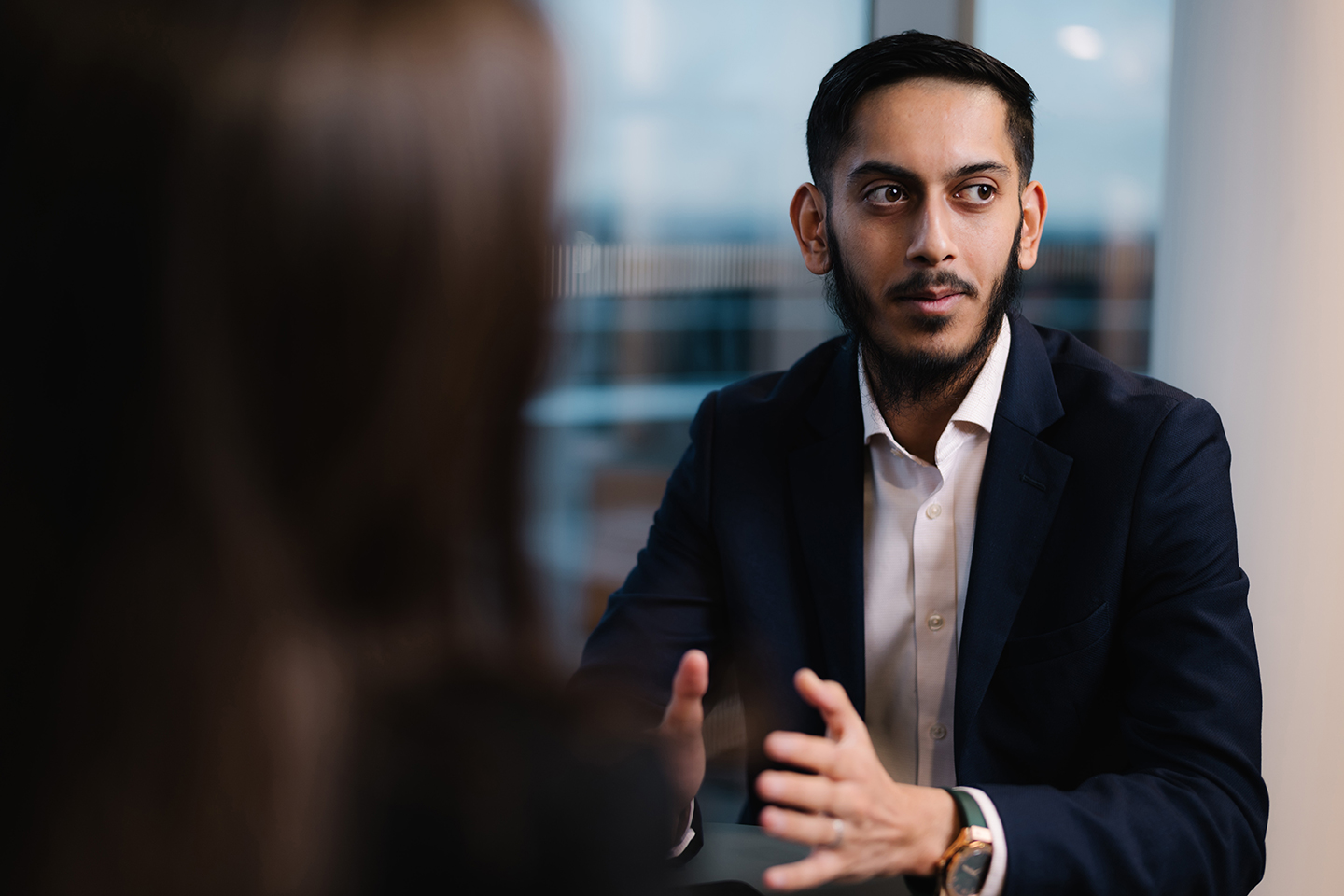 a man in a suit talking to a woman