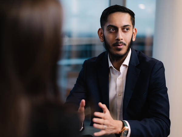 a man in a suit talking to a woman