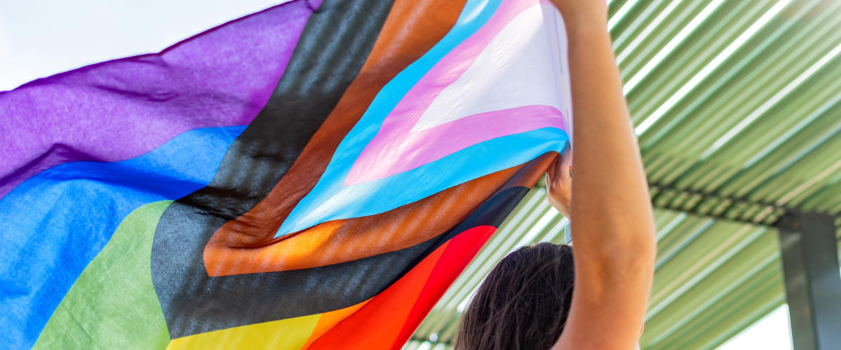 a person holding a colorful flag