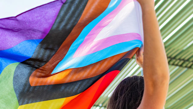 a person holding a colorful flag
