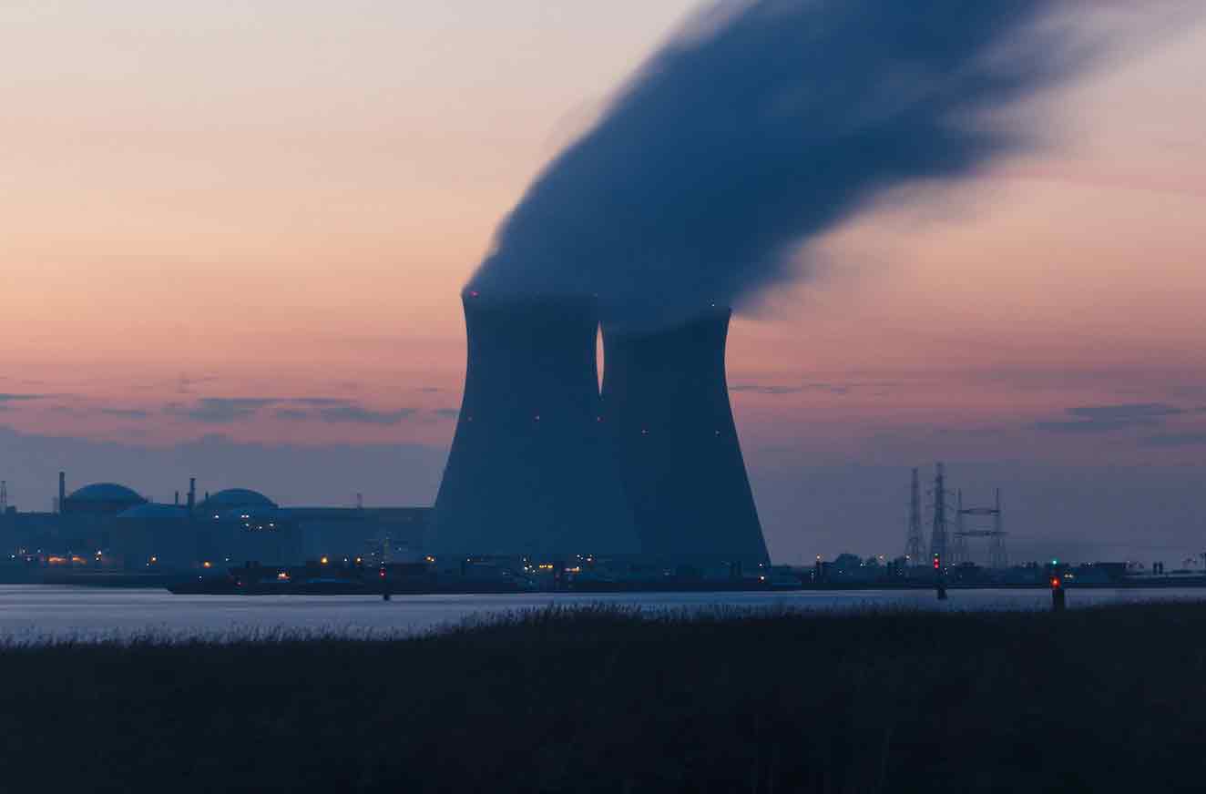 a nuclear power plant with smoke coming out of it