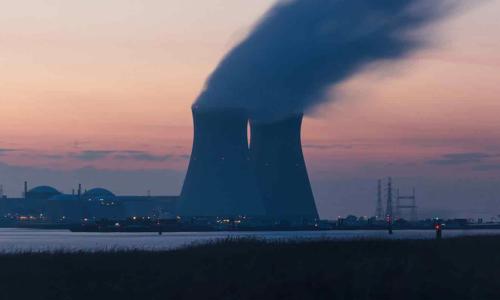 a nuclear power plant with smoke coming out of it