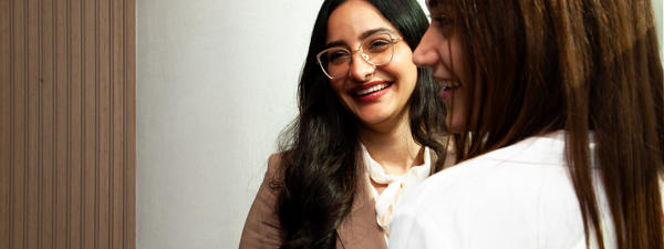 a woman smiling at another woman
