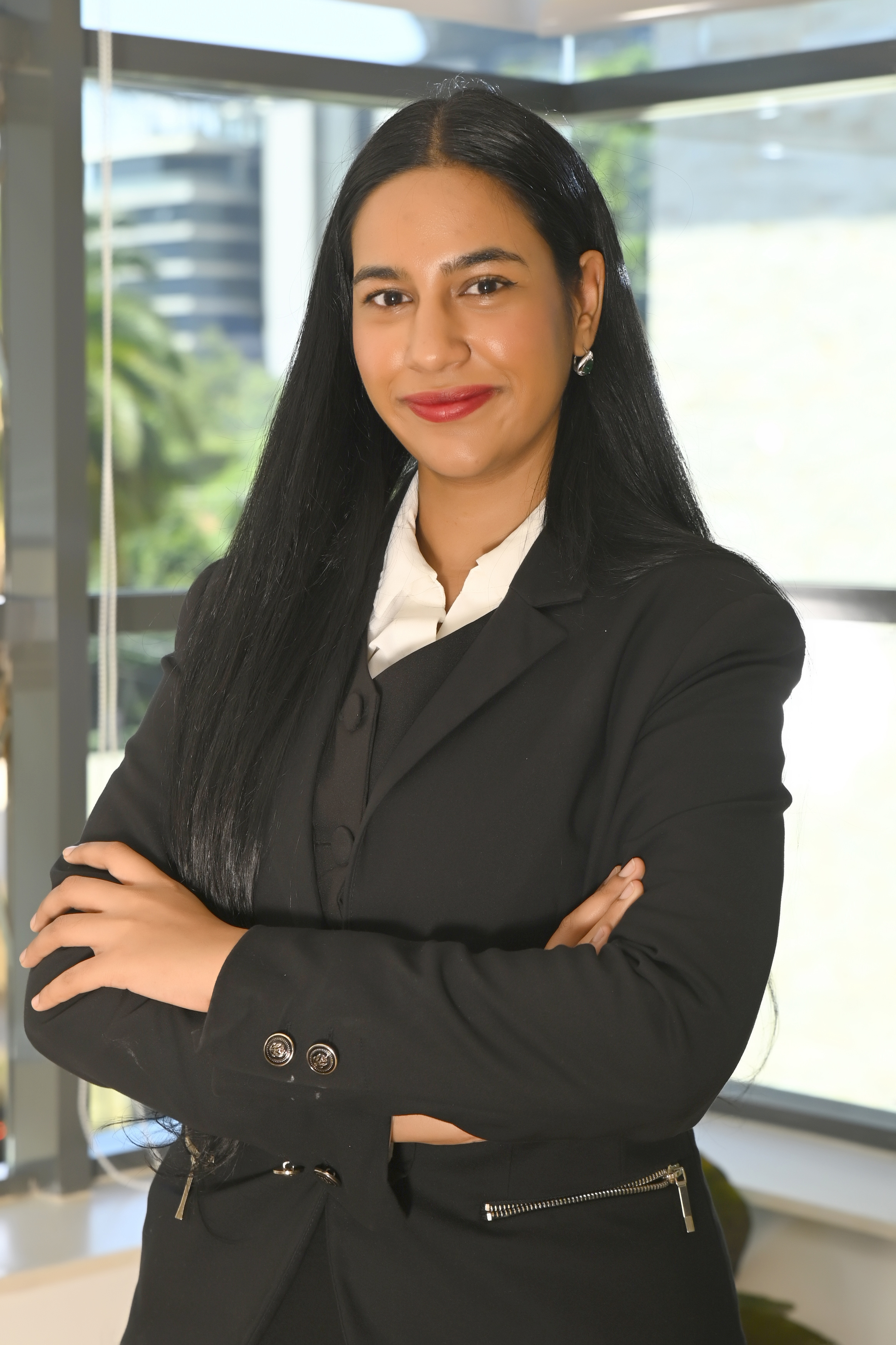 a woman with long black hair wearing a black suit