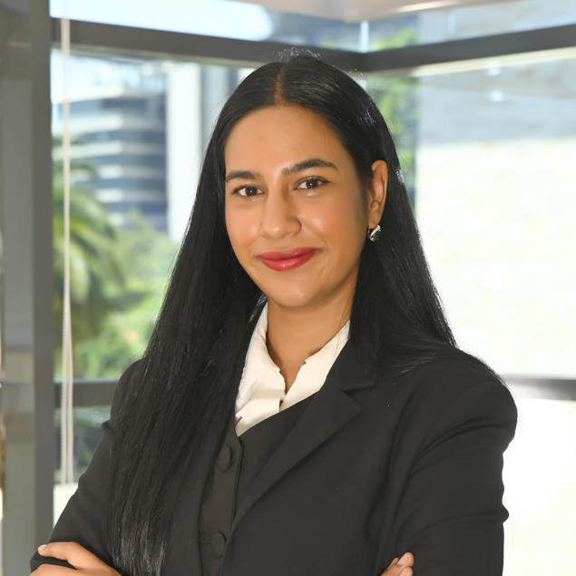 a woman with long black hair wearing a black suit