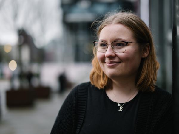 a woman wearing glasses and a black shirt