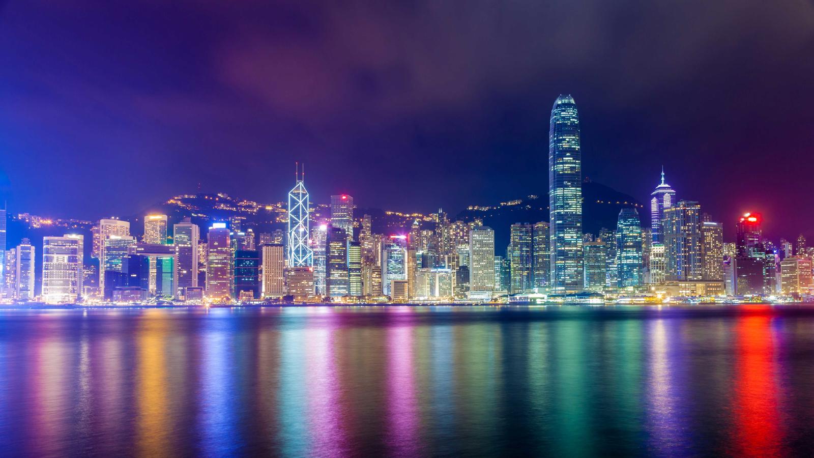 a city skyline with lights reflecting on water