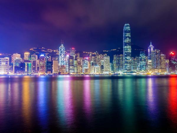 a city skyline with lights reflecting on water