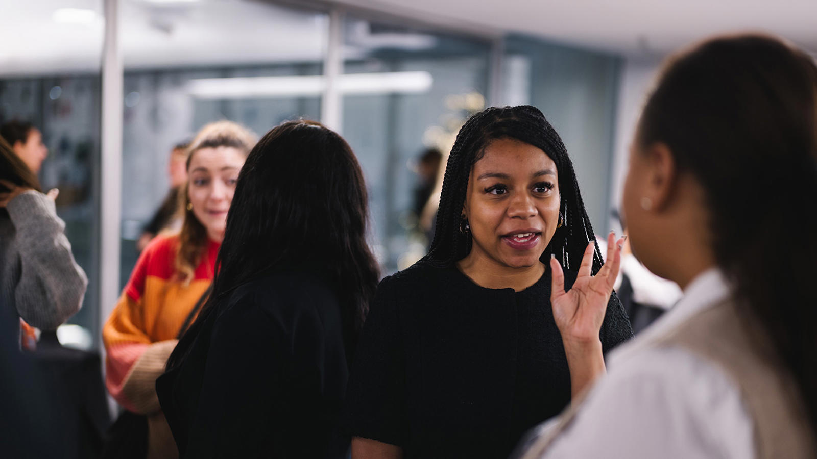 a group of women talking in a room