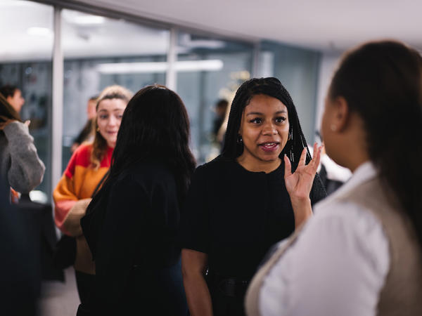a group of women talking in a room