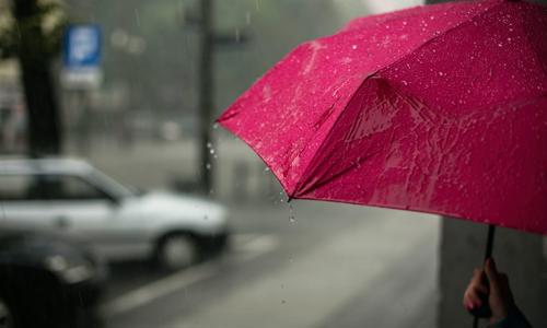 a pink umbrella with raindrops on it