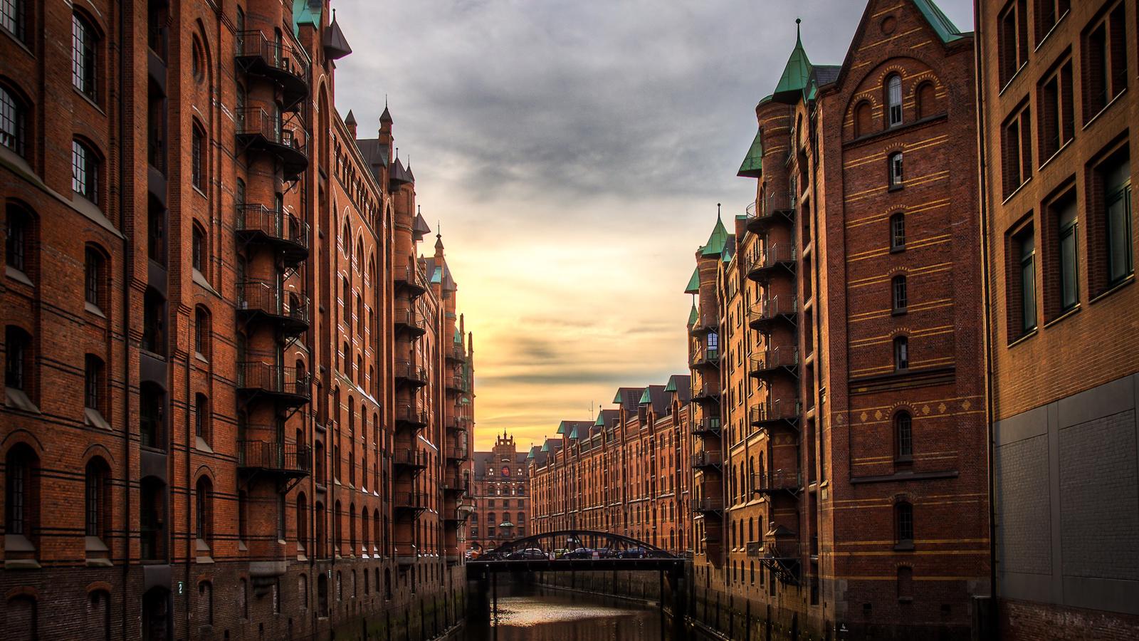 a river between buildings with a bridge