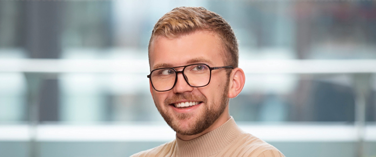 a man wearing glasses and a turtleneck