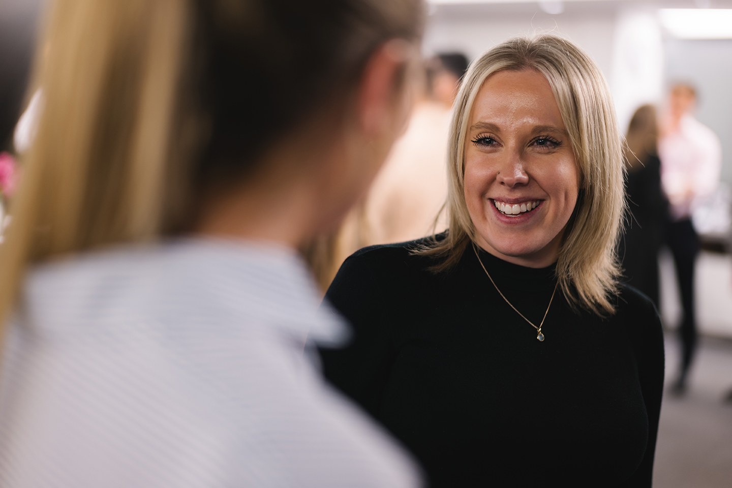 a woman smiling at another woman