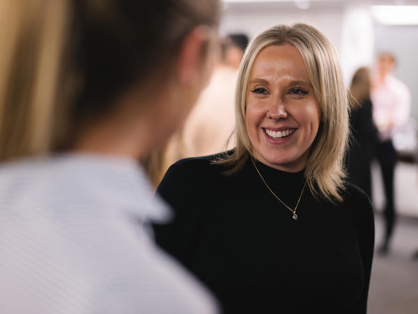a woman smiling at another woman