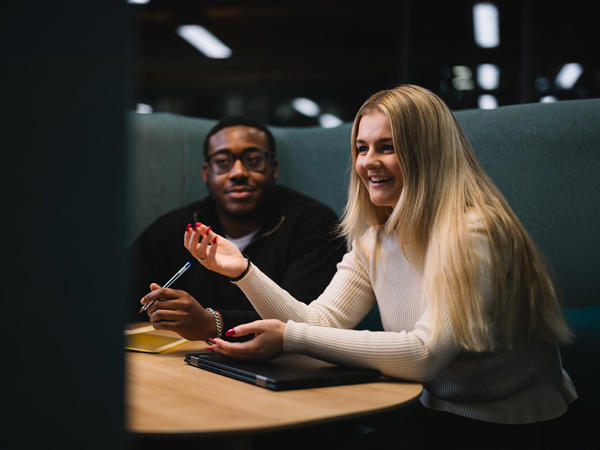 a man and woman sitting at a table