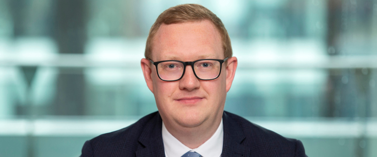 a man wearing glasses and a suit