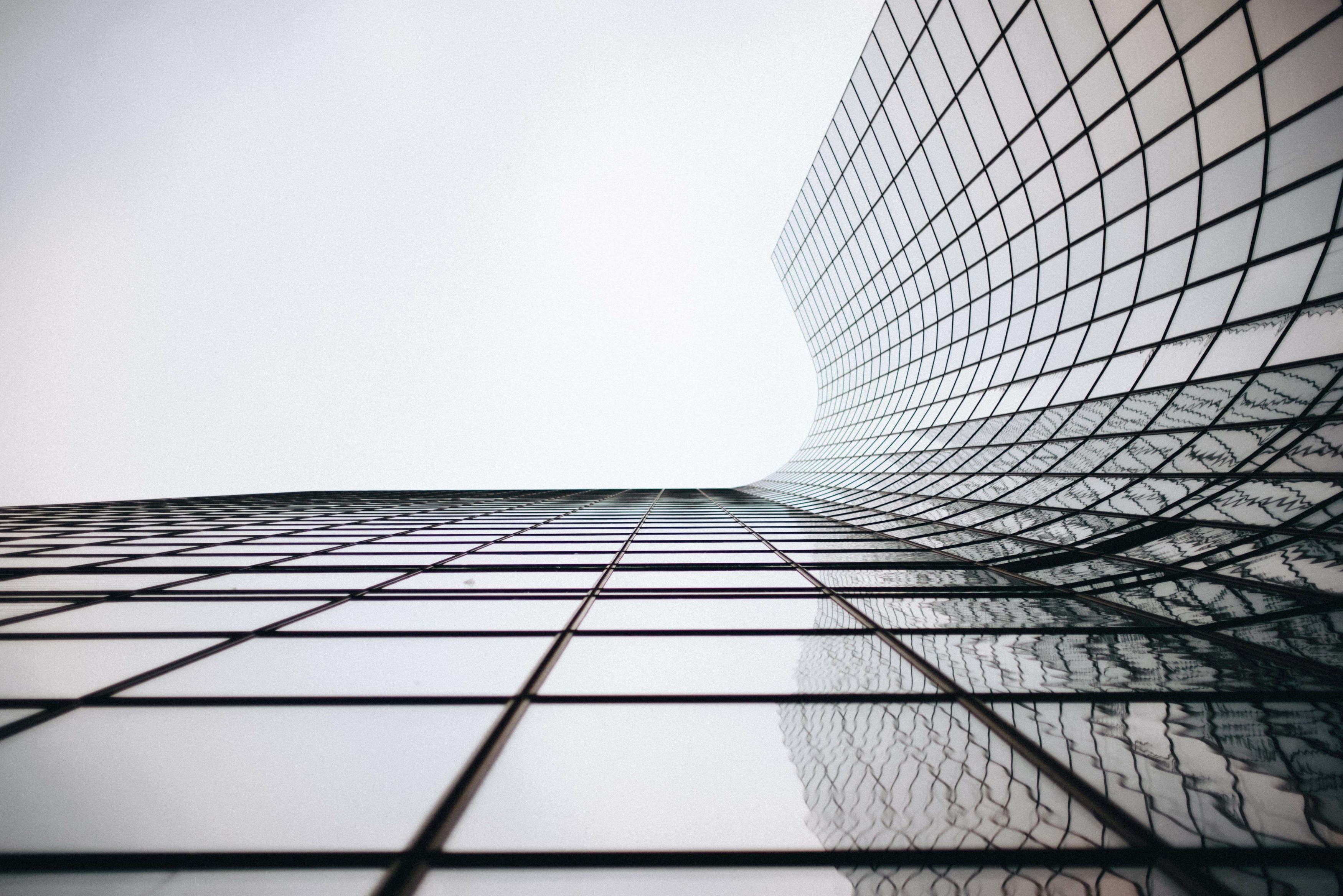 a glass building with a curved roof