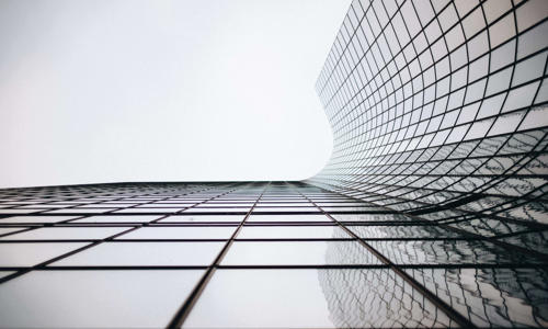 a glass building with a curved roof