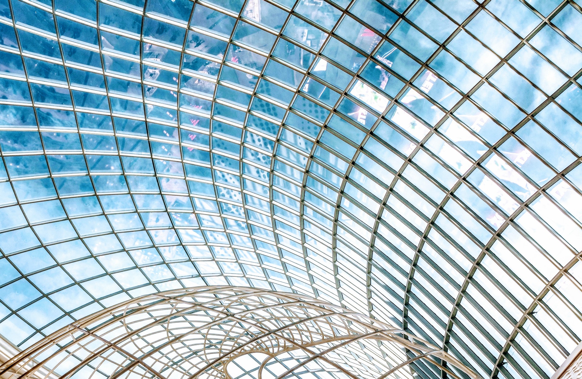 a glass roof with a curved structure