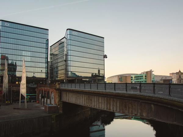a bridge over a river with a bridge and buildings