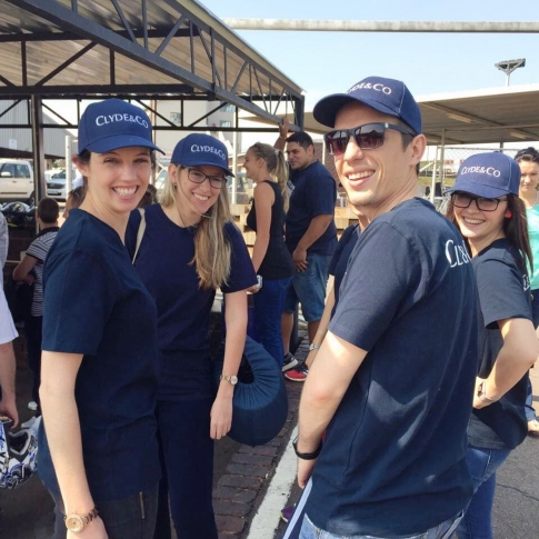 a group of people wearing blue hats and smiling