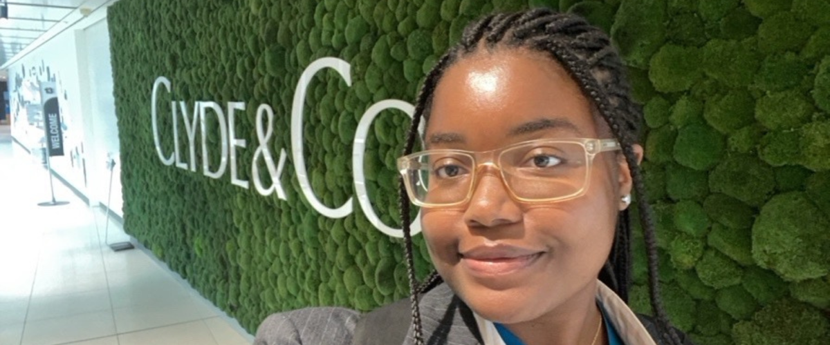 a woman wearing glasses and smiling