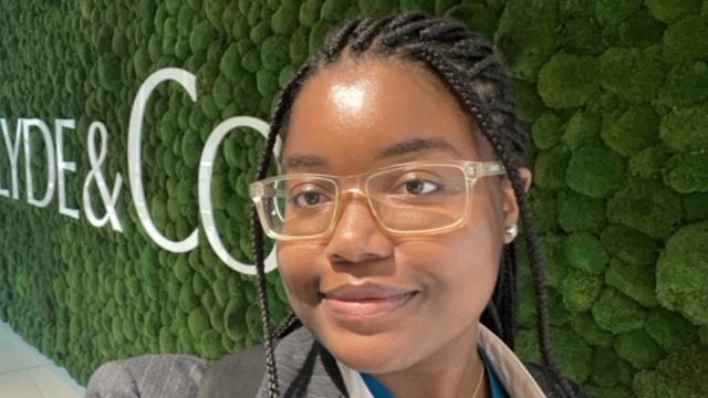 a woman wearing glasses and smiling