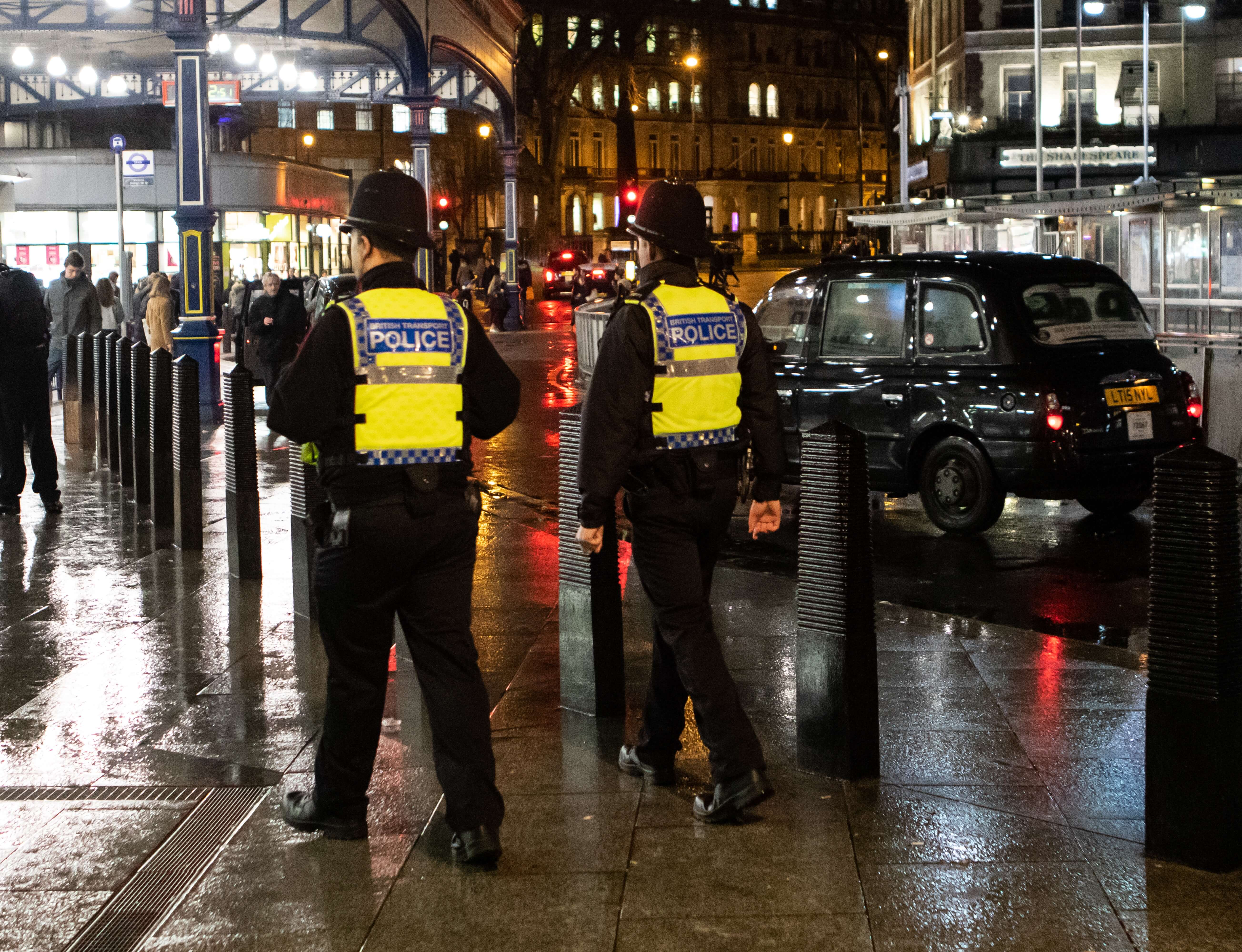 two police officers on a sidewalk