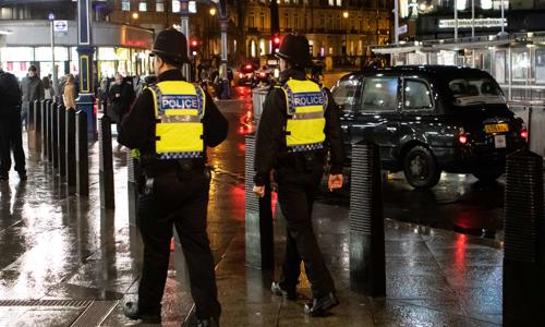 two police officers on a sidewalk