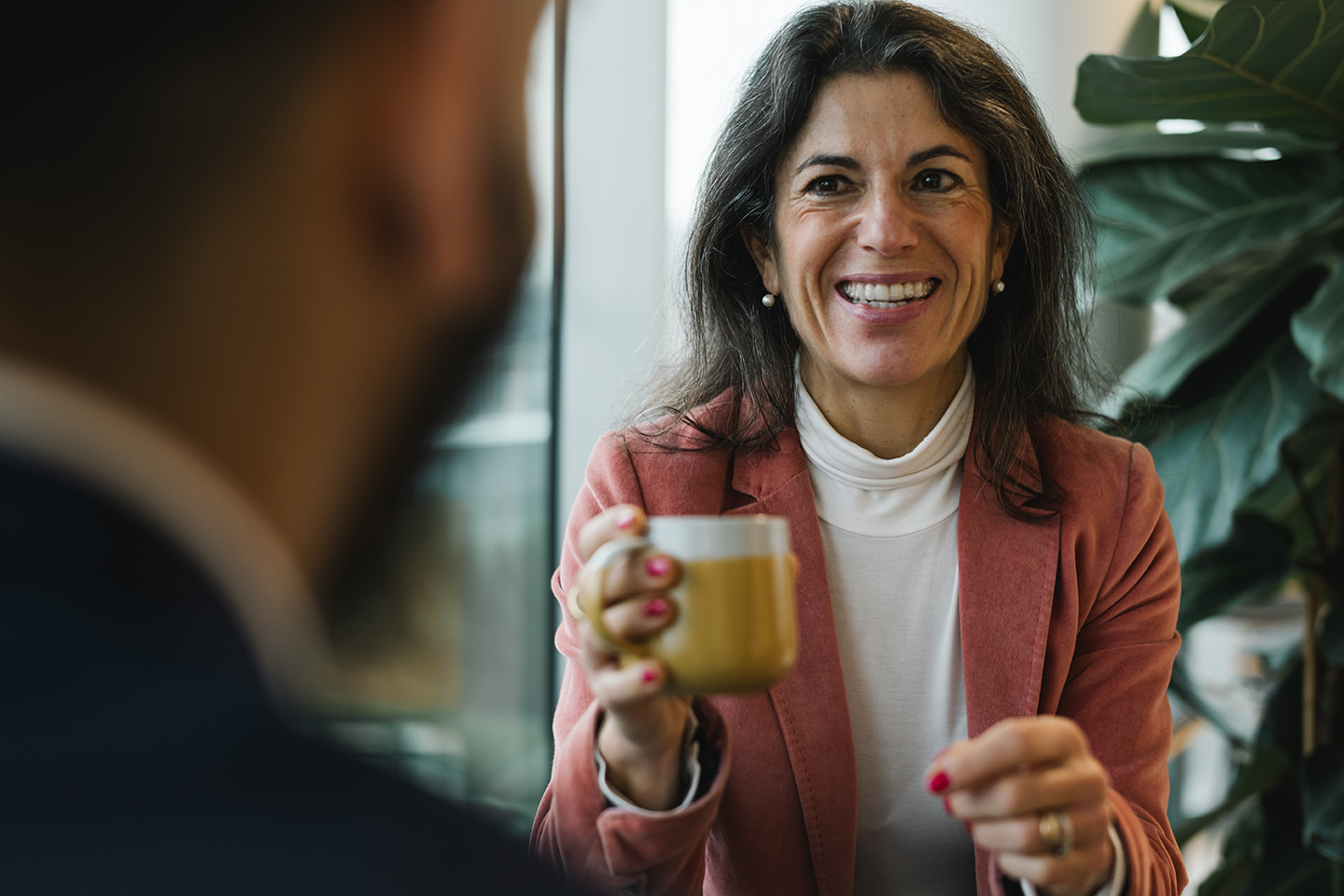 a woman holding a cup of coffee