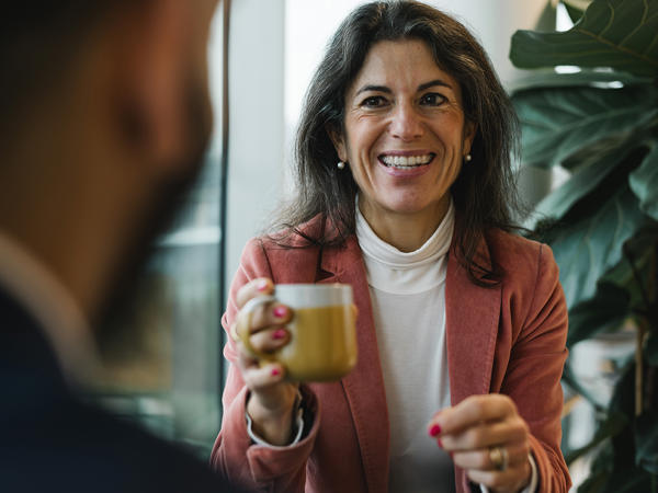 a woman holding a cup of coffee