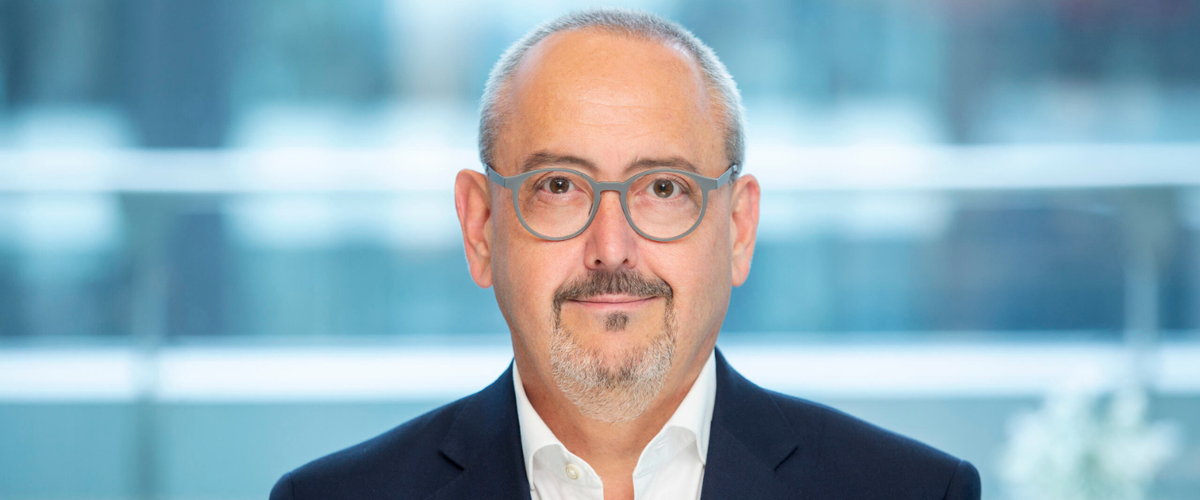 a man wearing glasses and a suit